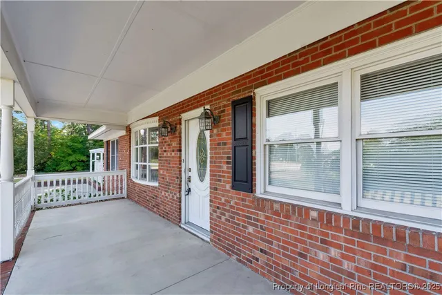 an empty room with window and wooden floor