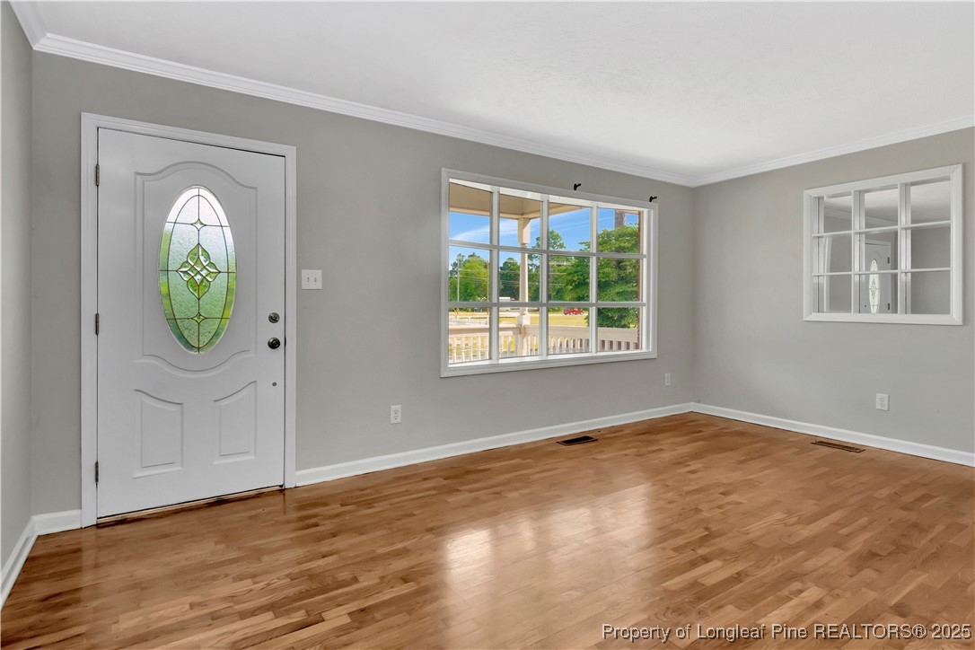 6036-6070 Camden Road Fayetteville, NC 28306 - Photo 7 of 45 an empty room with window and wooden floor