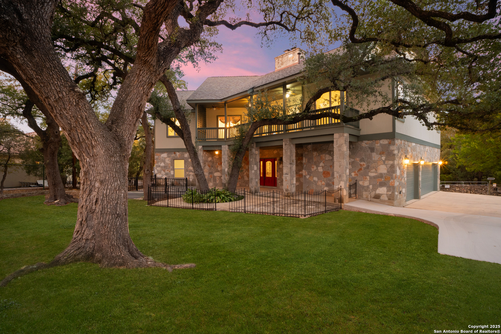 1245 Phantom Rider Trail Spring Branch, TX 78070 - Photo 1 of 51 a front view of a house with a garden and tree