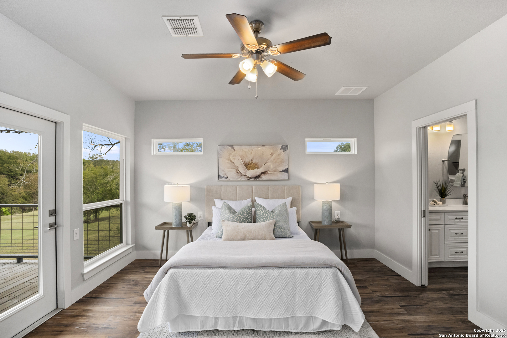 1245 Phantom Rider Trail Spring Branch, TX 78070 - Photo 14 of 51 a bedroom with a large bed and a chandelier