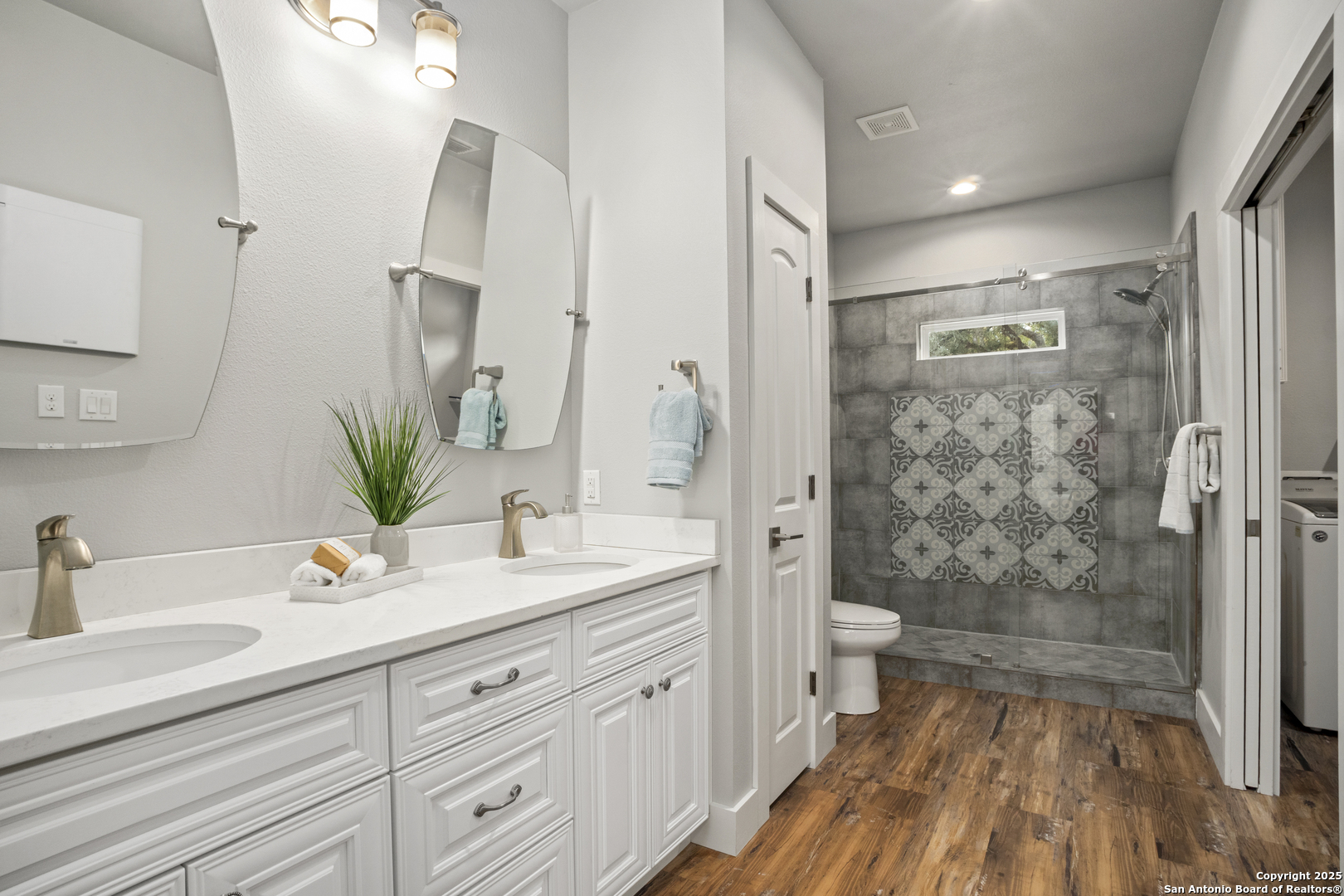 1245 Phantom Rider Trail Spring Branch, TX 78070 - Photo 15 of 51 a spacious bathroom with a granite countertop sink a toilet a mirror and shower
