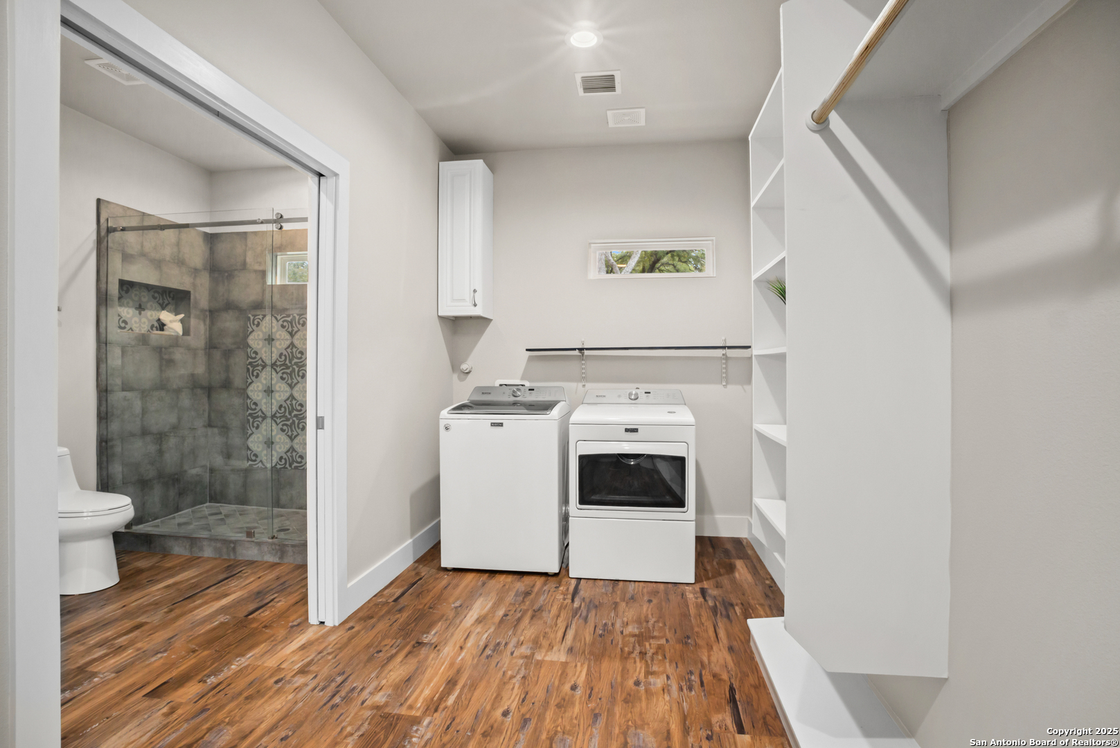 1245 Phantom Rider Trail Spring Branch, TX 78070 - Photo 16 of 51 a view of washer and dryer with wooden floor