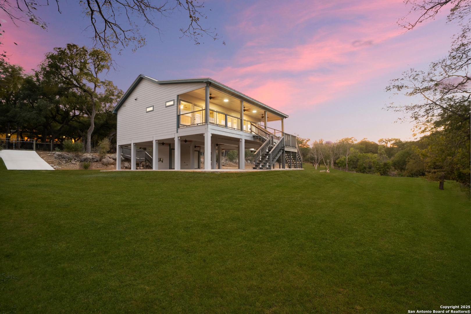 1245 Phantom Rider Trail Spring Branch, TX 78070 - Photo 2 of 51 a front view of a house with a garden