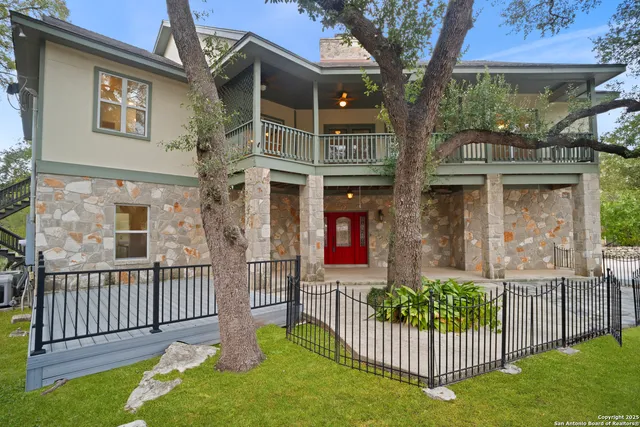 a living room with fireplace furniture and a large window