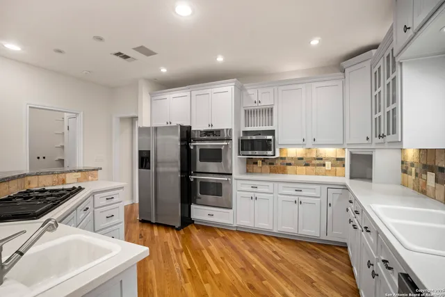 a bedroom with a balcony a bed and a chandelier