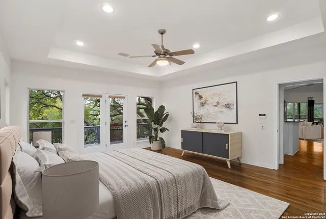 a spacious bedroom with a large bed and a large window