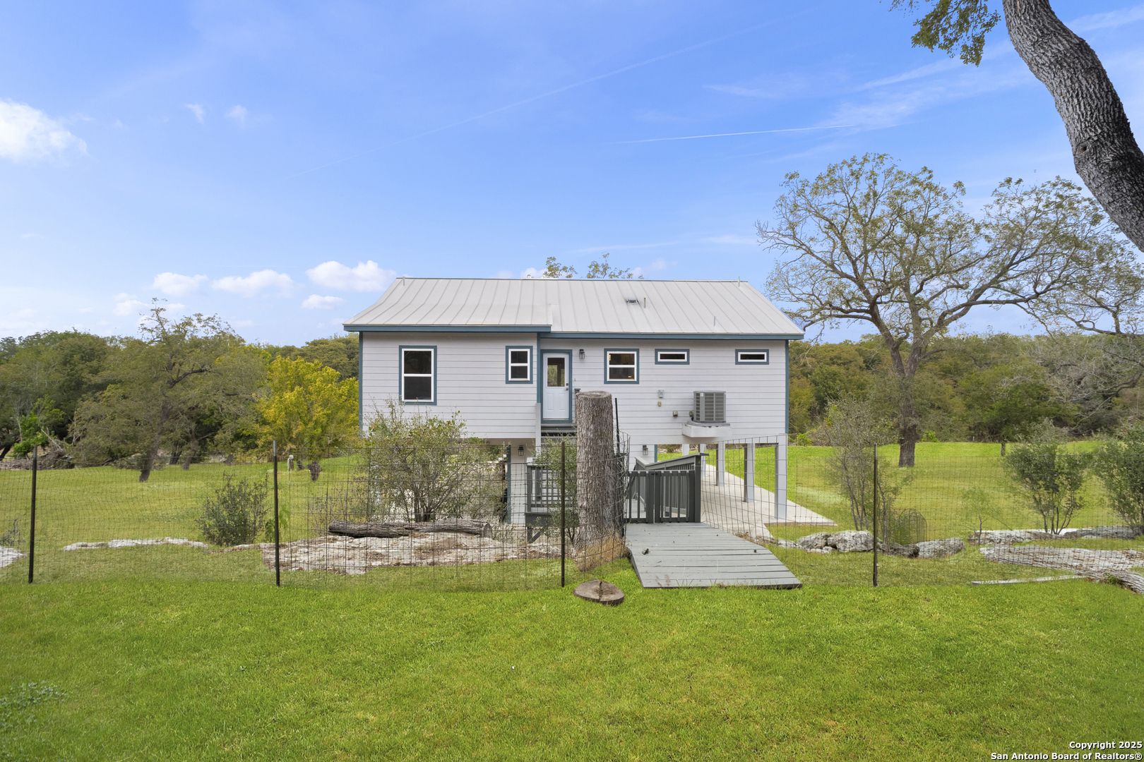 1245 Phantom Rider Trail Spring Branch, TX 78070 - Photo 27 of 48 a view of a house with a yard and sitting area