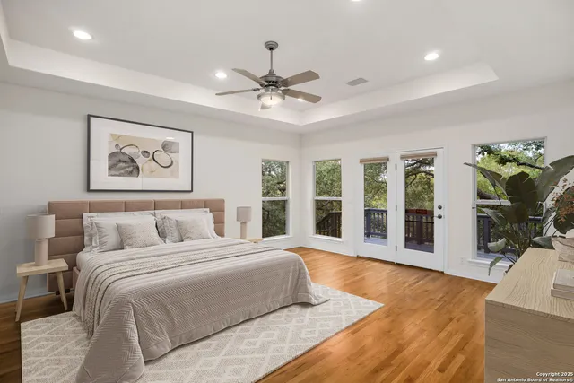 a spacious bathroom with a double vanity sink a mirror a bathtub and window