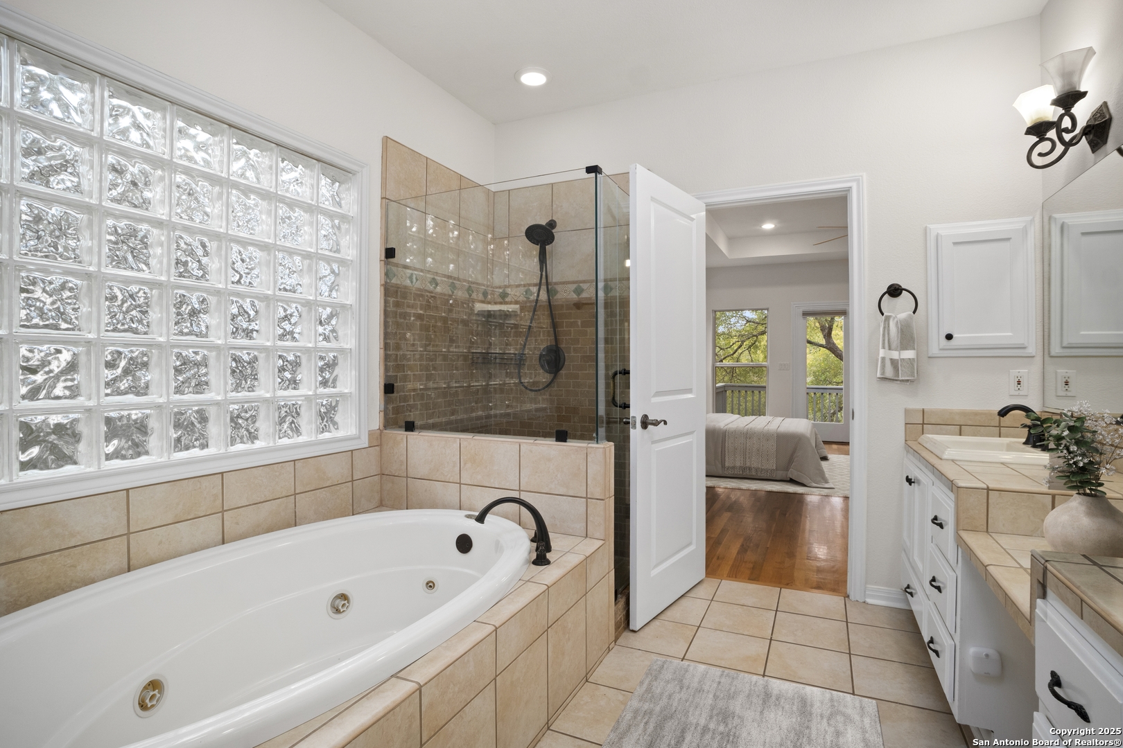 1245 Phantom Rider Trail Spring Branch, TX 78070 - Photo 30 of 51 a bathroom with a bathtub a sink a mirror and a shower