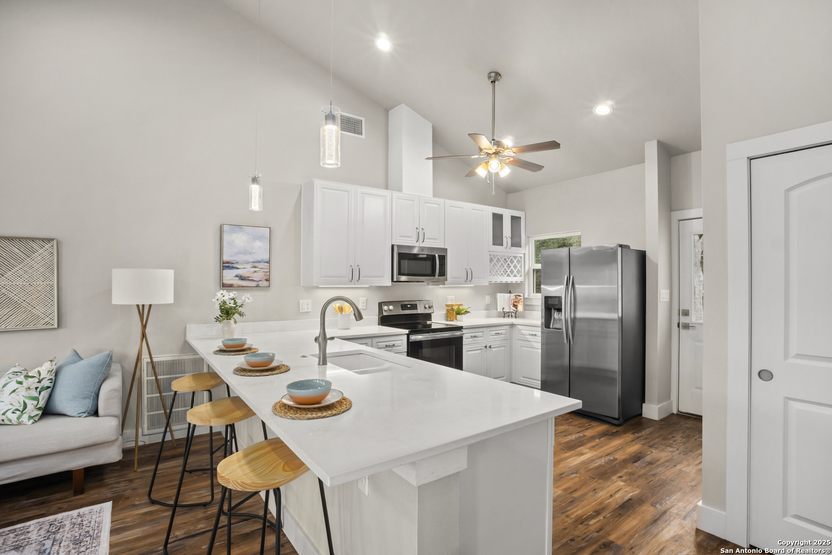 1245 Phantom Rider Trail Spring Branch, TX 78070 - Photo 33 of 48 a kitchen with a refrigerator a stove a sink a dining table and chairs