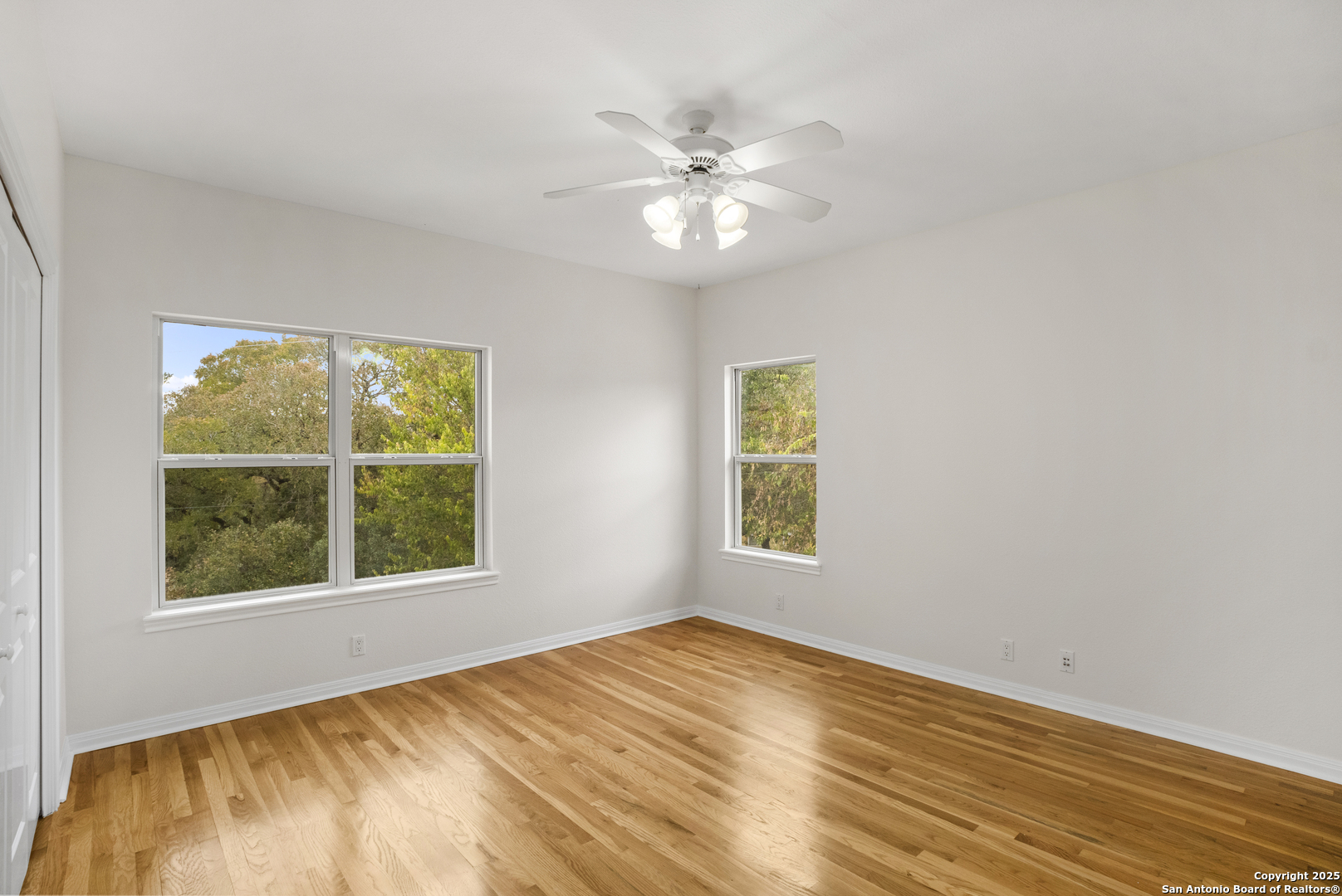 1245 Phantom Rider Trail Spring Branch, TX 78070 - Photo 33 of 51 a view of an empty room with wooden floor and a window