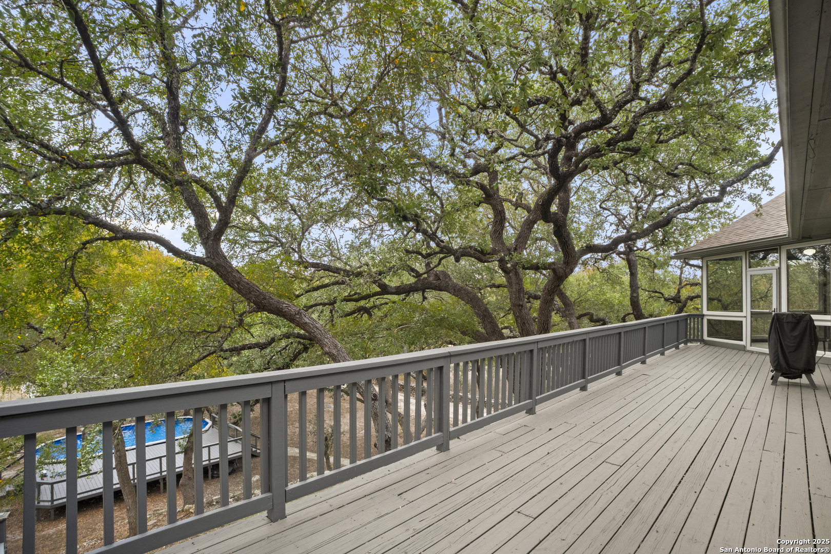 1245 Phantom Rider Trail Spring Branch, TX 78070 - Photo 36 of 51 a view of a wooden deck with trees