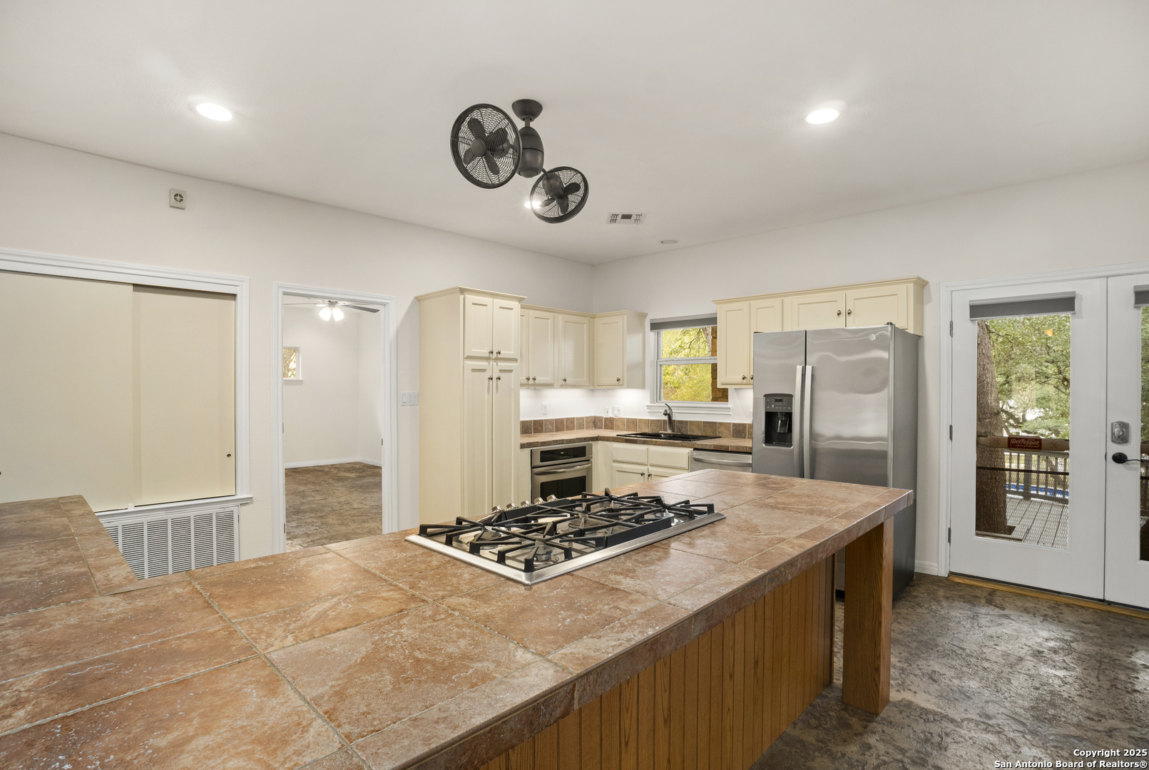 1245 Phantom Rider Trail Spring Branch, TX 78070 - Photo 39 of 51 a kitchen with a stove and a refrigerator