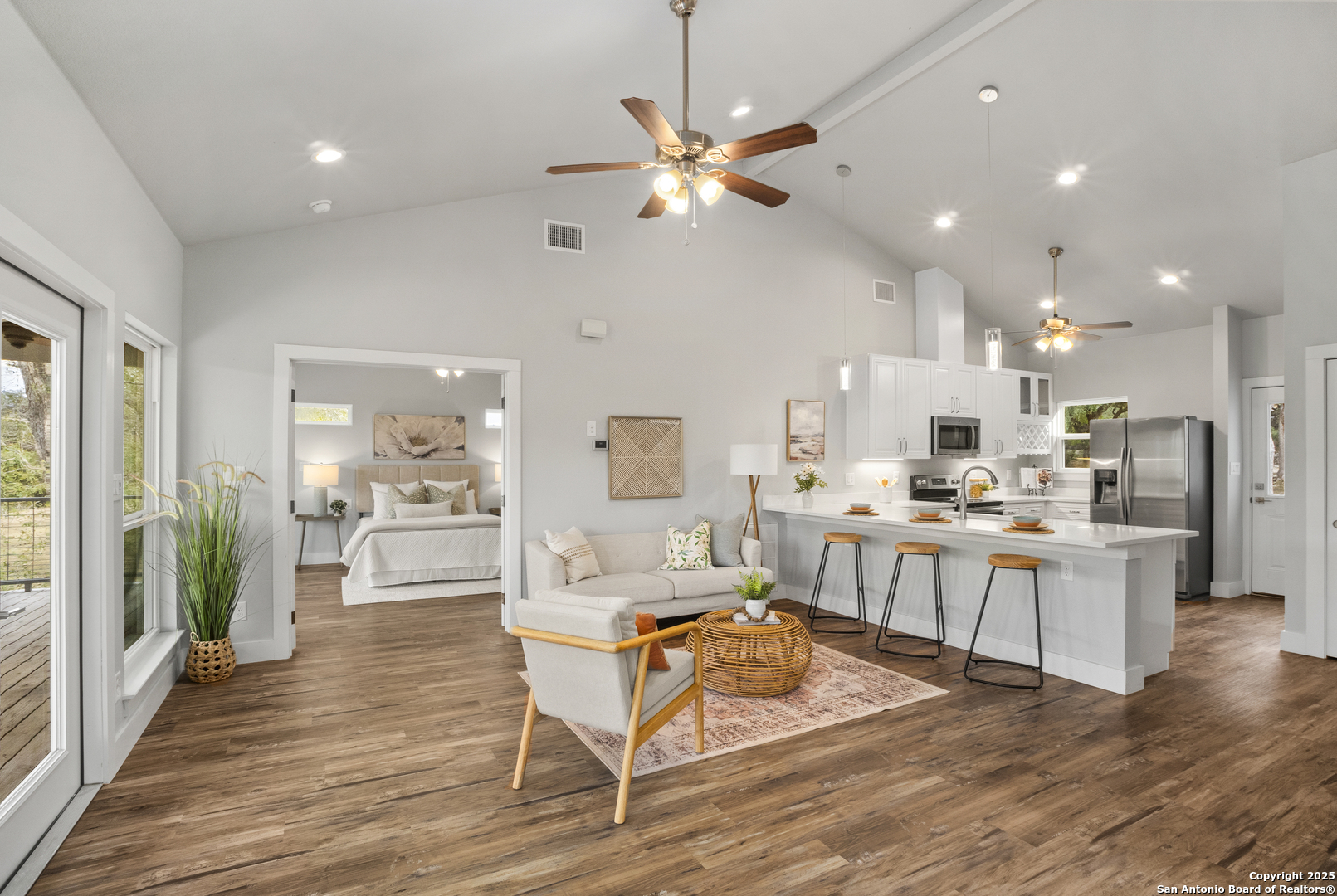 1245 Phantom Rider Trail Spring Branch, TX 78070 - Photo 9 of 51 a living room with kitchen island furniture and a wooden floor