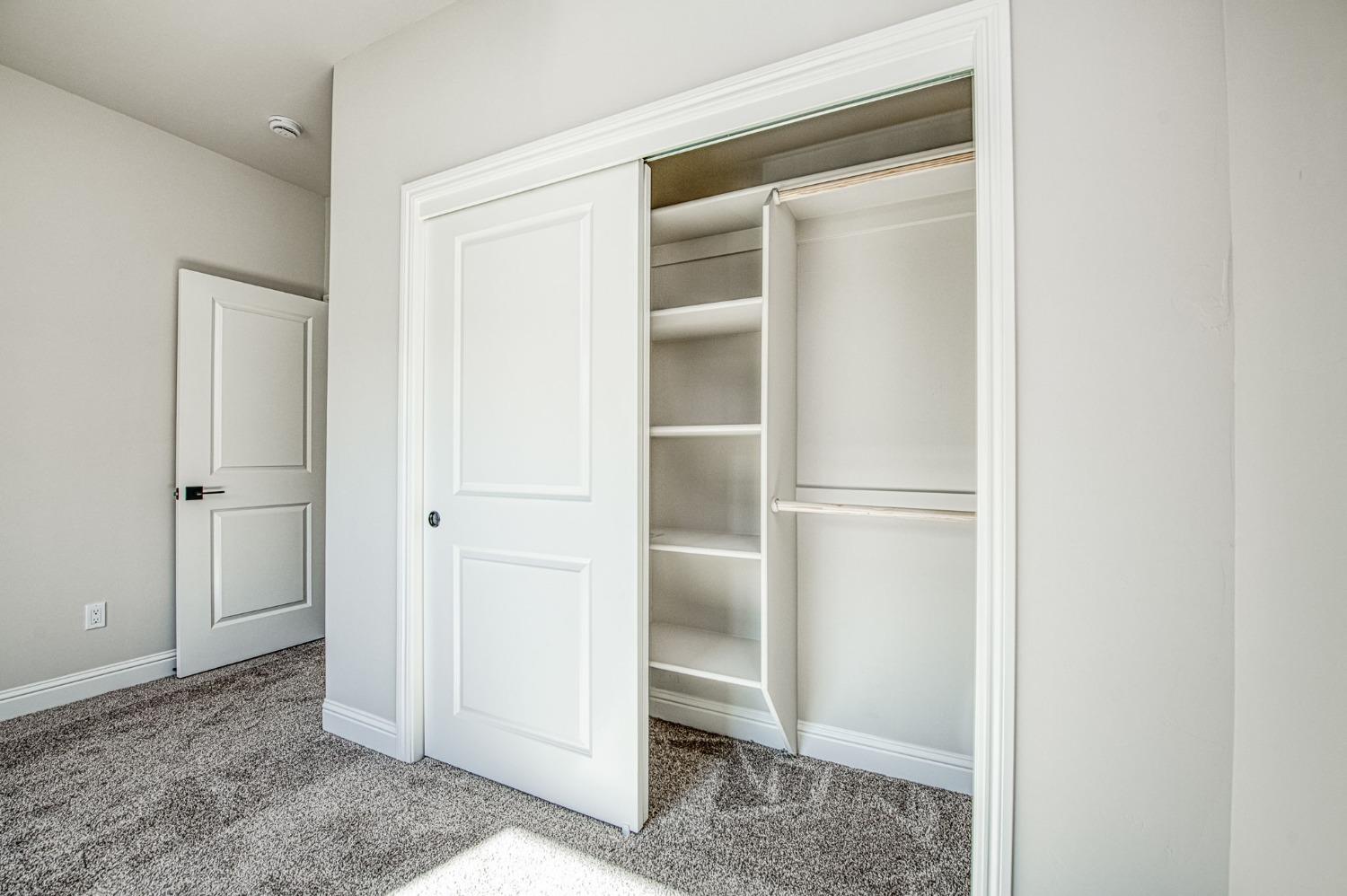 11271 Mountain View Drive Madera, CA 93636 - Photo 14 of 73 a view of walk in closet with empty racks