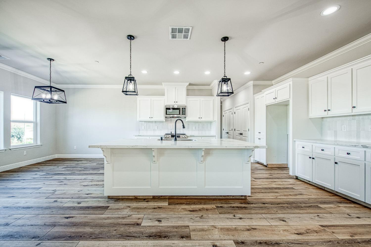 11271 Mountain View Drive Madera, CA 93636 - Photo 16 of 73 a view of a kitchen with kitchen island a sink stainless steel appliances and cabinets