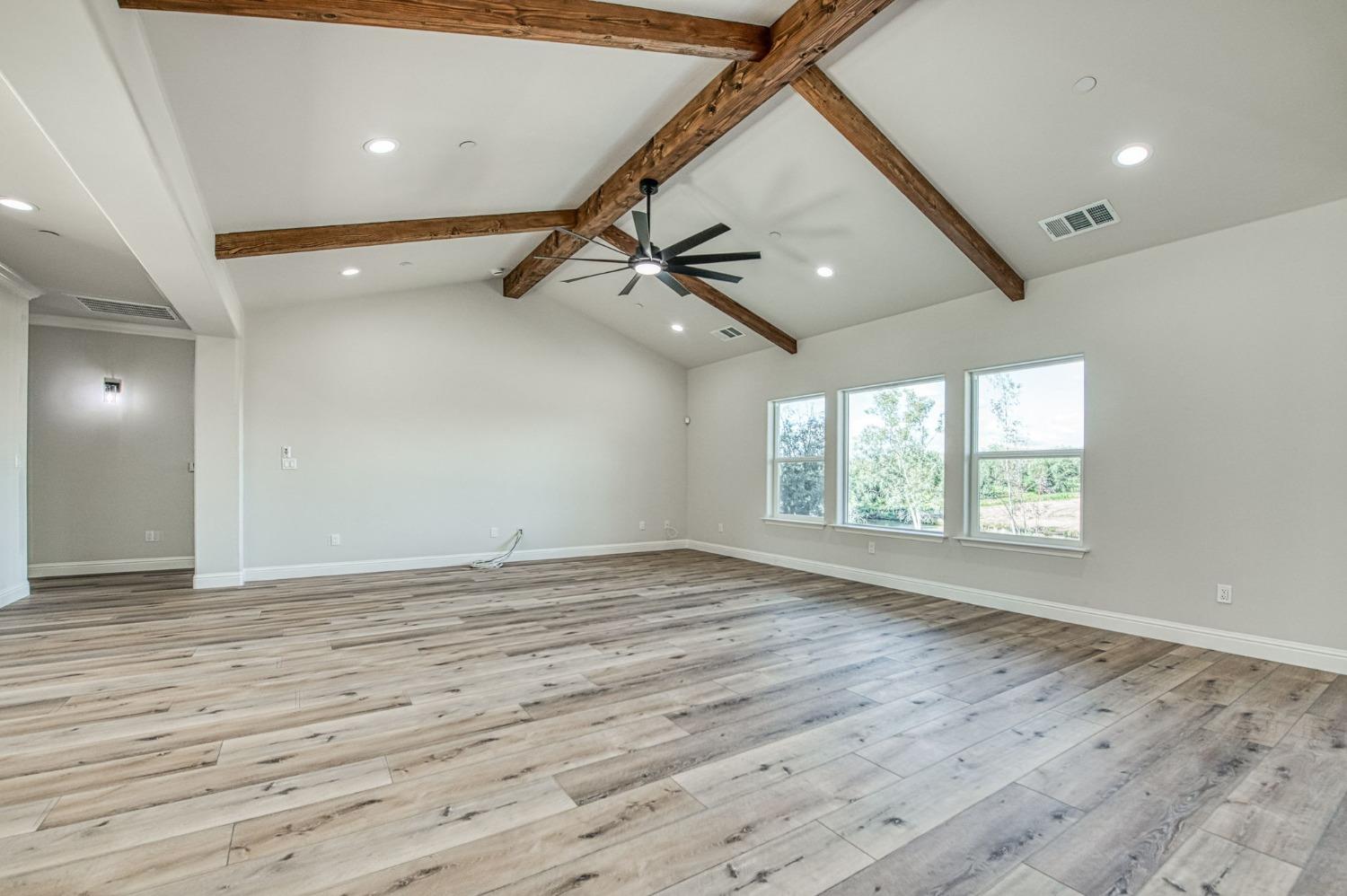 11271 Mountain View Drive Madera, CA 93636 - Photo 19 of 73 an empty room with wooden floor fan and windows