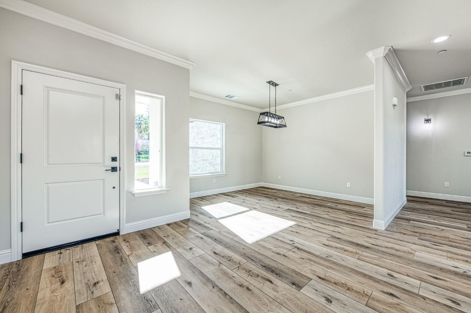 11271 Mountain View Drive Madera, CA 93636 - Photo 23 of 73 wooden floor in an empty room with a window