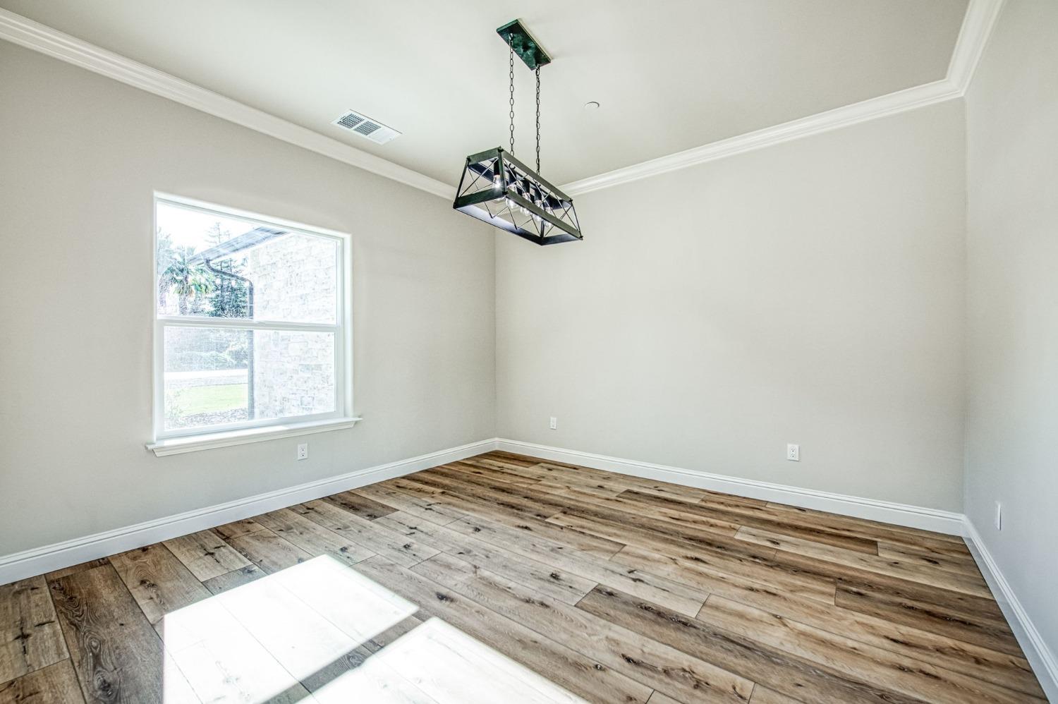 11271 Mountain View Drive Madera, CA 93636 - Photo 24 of 73 a view of a room with a window and wooden floor