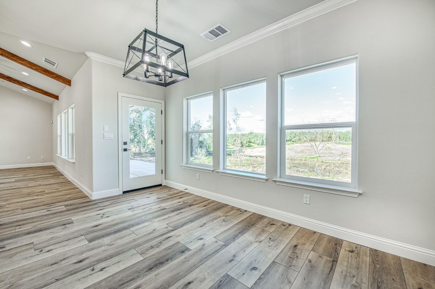 11271 Mountain View Drive Madera, CA 93636 - Photo 31 of 73 a view of a room with wooden floor and windows