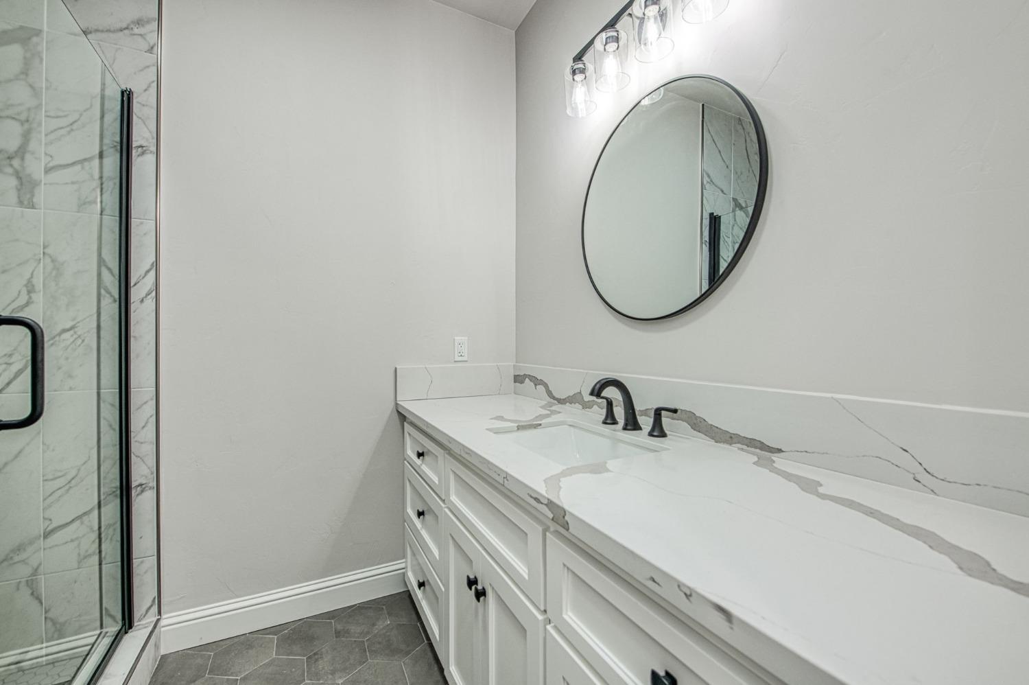 11271 Mountain View Drive Madera, CA 93636 - Photo 34 of 73 a bathroom with a sink and a mirror