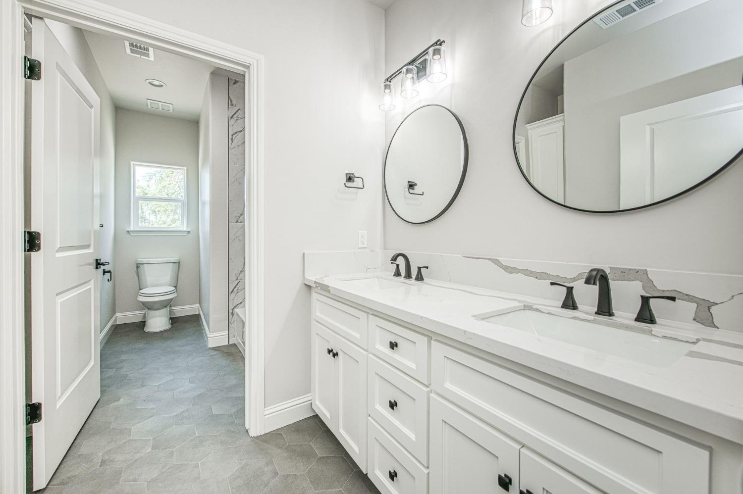 11271 Mountain View Drive Madera, CA 93636 - Photo 40 of 73 a spacious bathroom with a double vanity sink mirror and a toilet