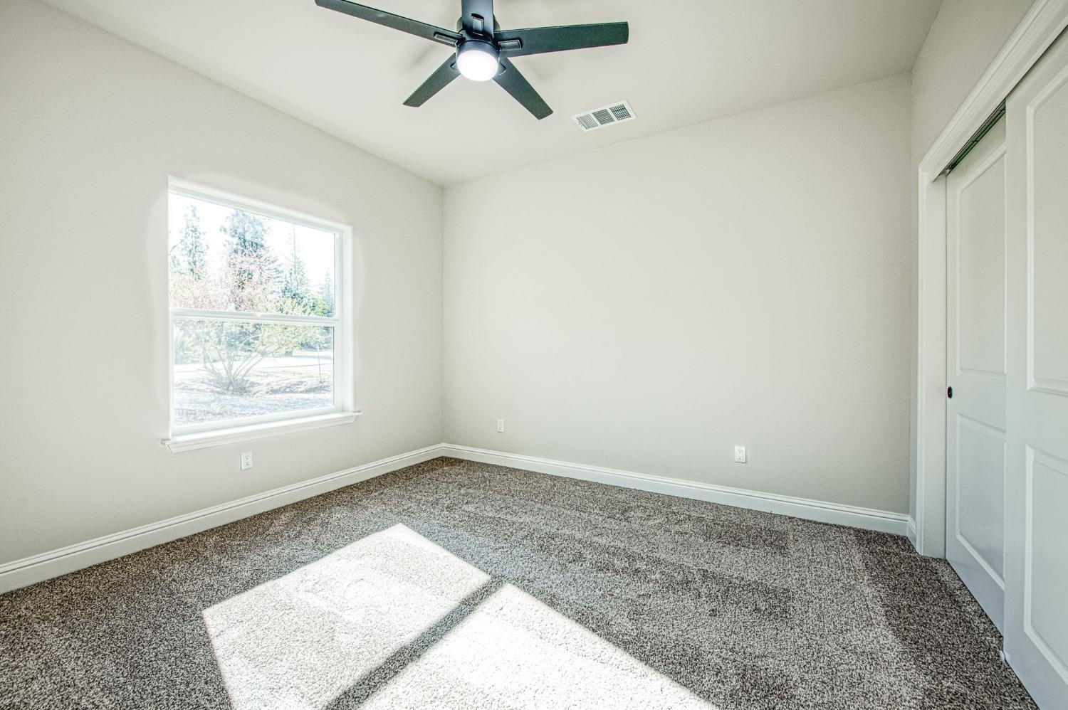 11271 Mountain View Drive Madera, CA 93636 - Photo 43 of 73 a view of a room with a window and a ceiling fan