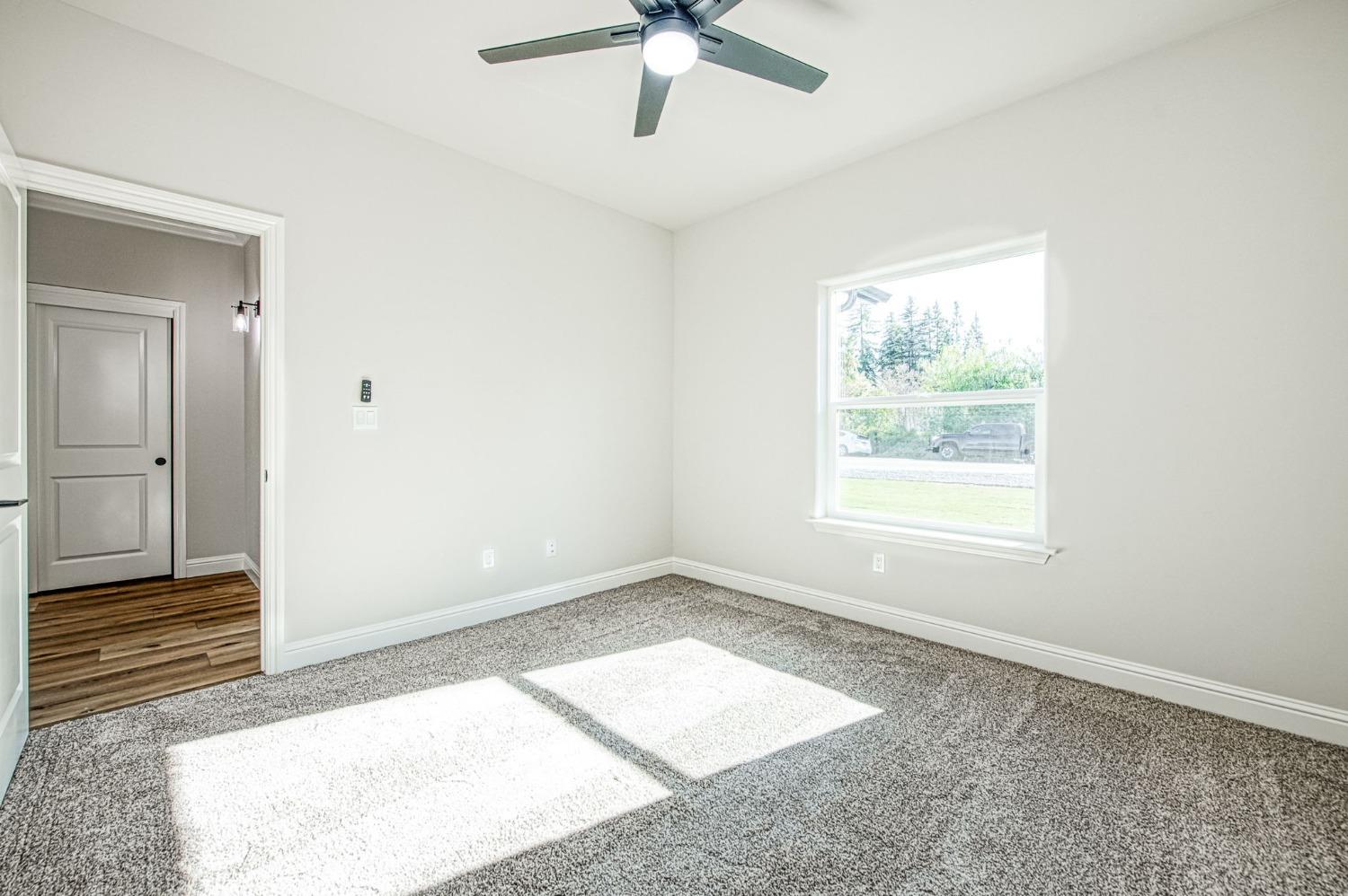11271 Mountain View Drive Madera, CA 93636 - Photo 44 of 73 a view of empty room with window and ceiling fan