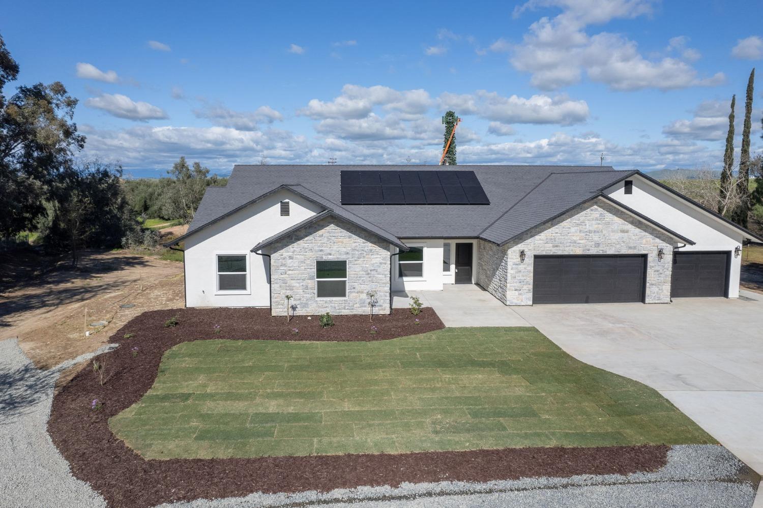 11271 Mountain View Drive Madera, CA 93636 - Photo 51 of 73 a front view of a house with a yard and garage
