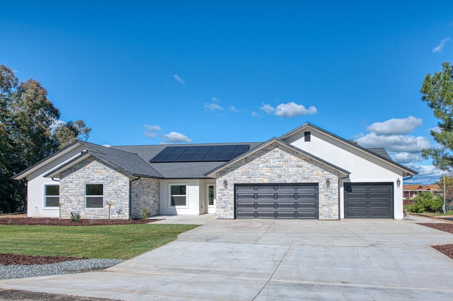 11271 Mountain View Drive Madera, CA 93636 - Photo 70 of 73 a front view of a house with a yard and garage