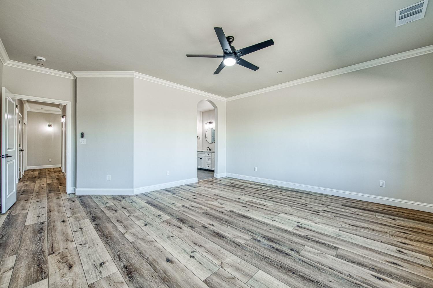 11271 Mountain View Drive Madera, CA 93636 - Photo 7 of 73 a view of a big room with wooden floor and windows