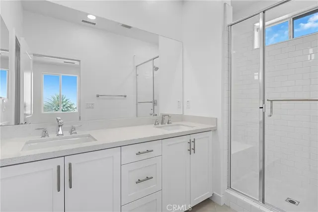 a bathroom with a double vanity sink and mirror