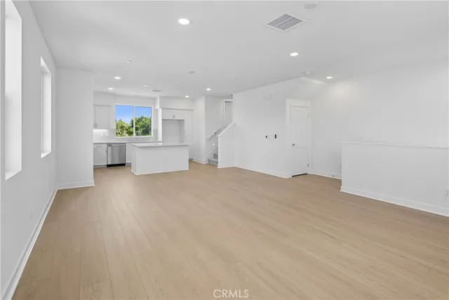 a view of room with window and wooden floor