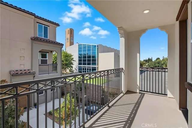 a view of a brick house with large windows and a wooden floor
