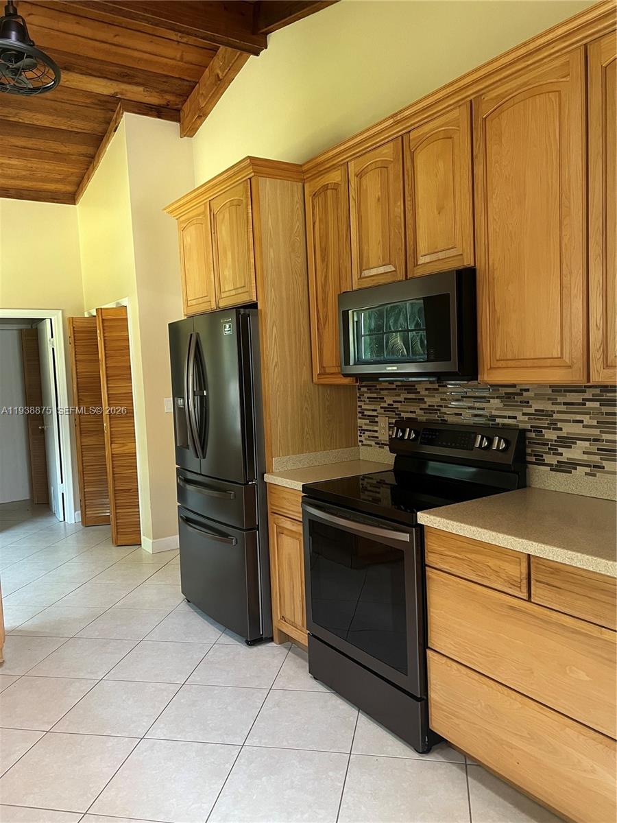 11501 Southwest 3rd Street Plantation, FL 33325 - Photo 12 of 16 a kitchen with stainless steel appliances granite countertop a refrigerator stove and microwave