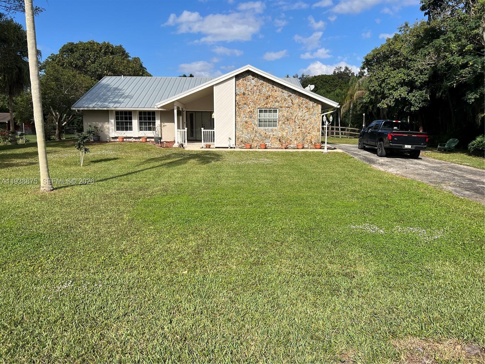 11501 Southwest 3rd Street Plantation, FL 33325 - Photo 3 of 16 a front view of a house with a yard