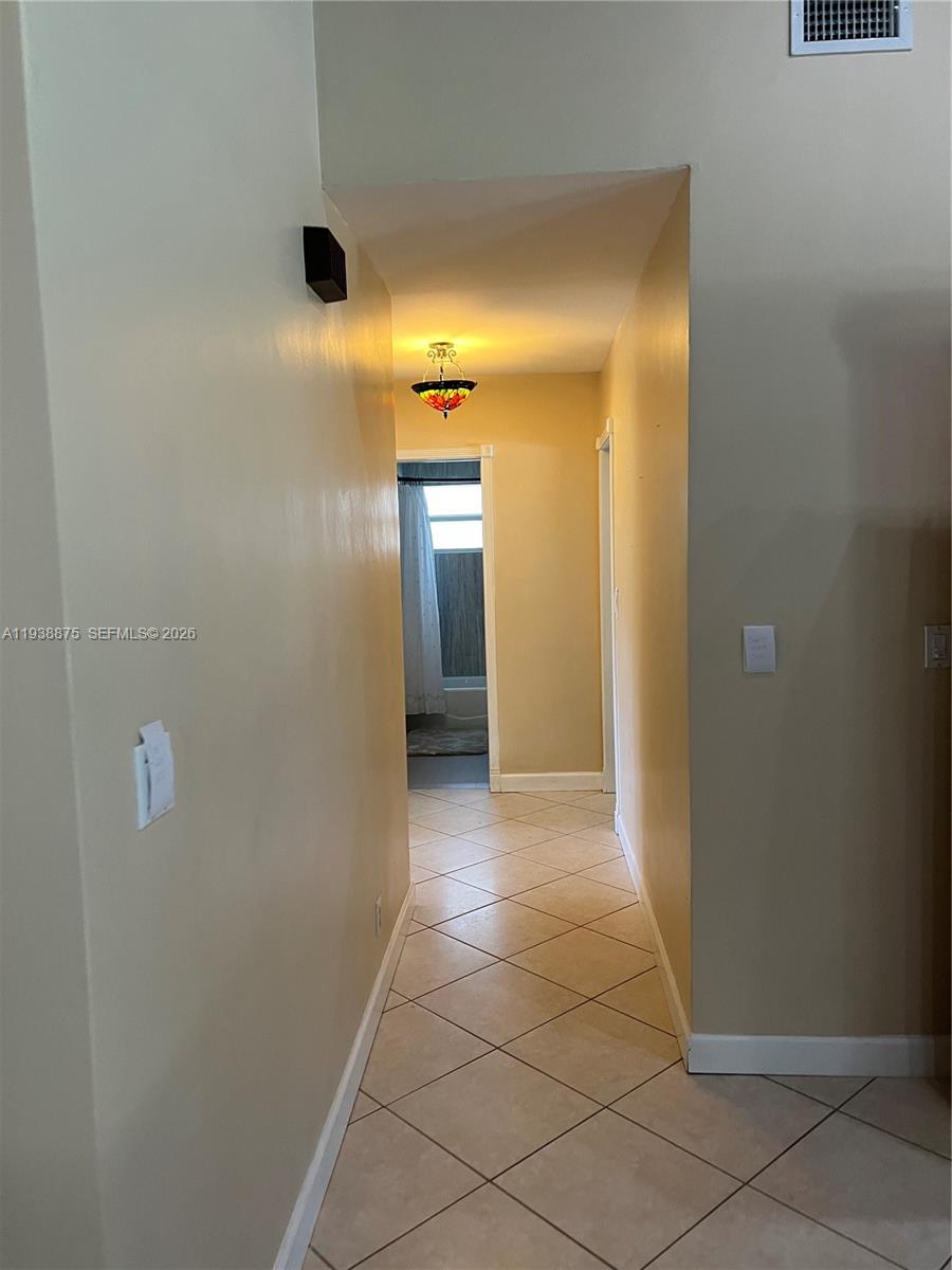 11501 Southwest 3rd Street Plantation, FL 33325 - Photo 7 of 16 a view of a hallway with wooden floor