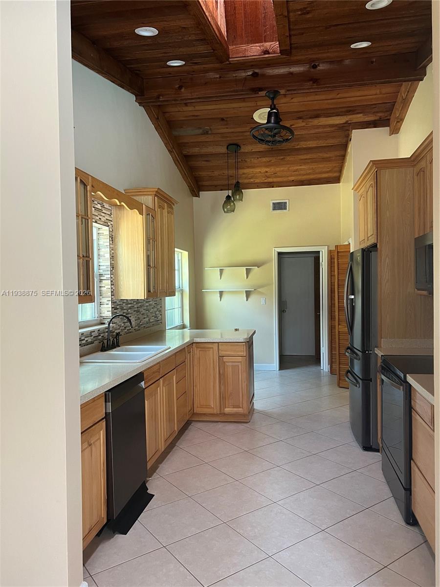 11501 Southwest 3rd Street Plantation, FL 33325 - Photo 10 of 16 a large kitchen with a large counter top a sink stainless steel appliances and cabinets