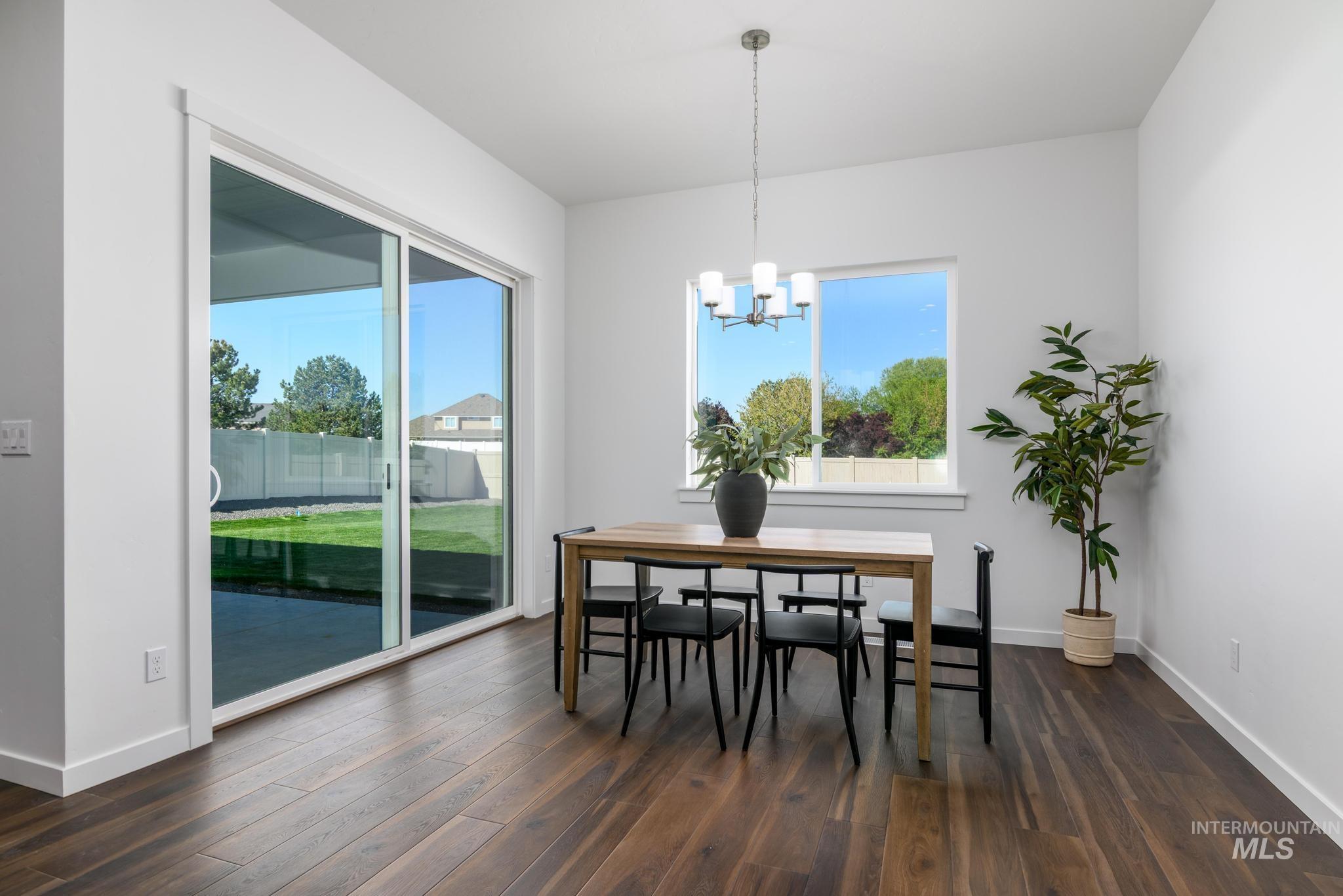 5324 Sparky Avenue Caldwell, ID 83607 - Photo 6 of 10 Dining area with hanging lights and dark wood finished floors