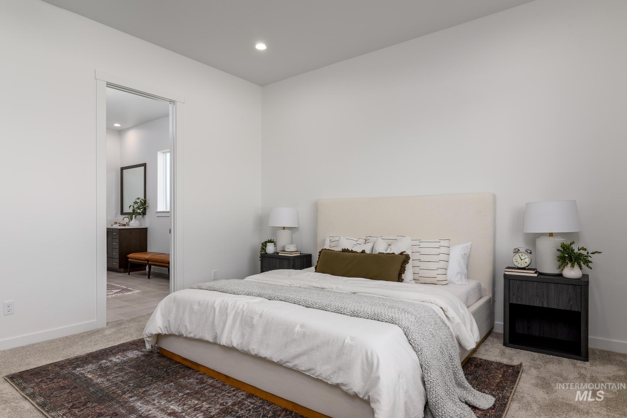 5324 Sparky Avenue Caldwell, ID 83607 - Photo 8 of 10 Bedroom featuring light carpet, recessed lighting, and connected bathroom