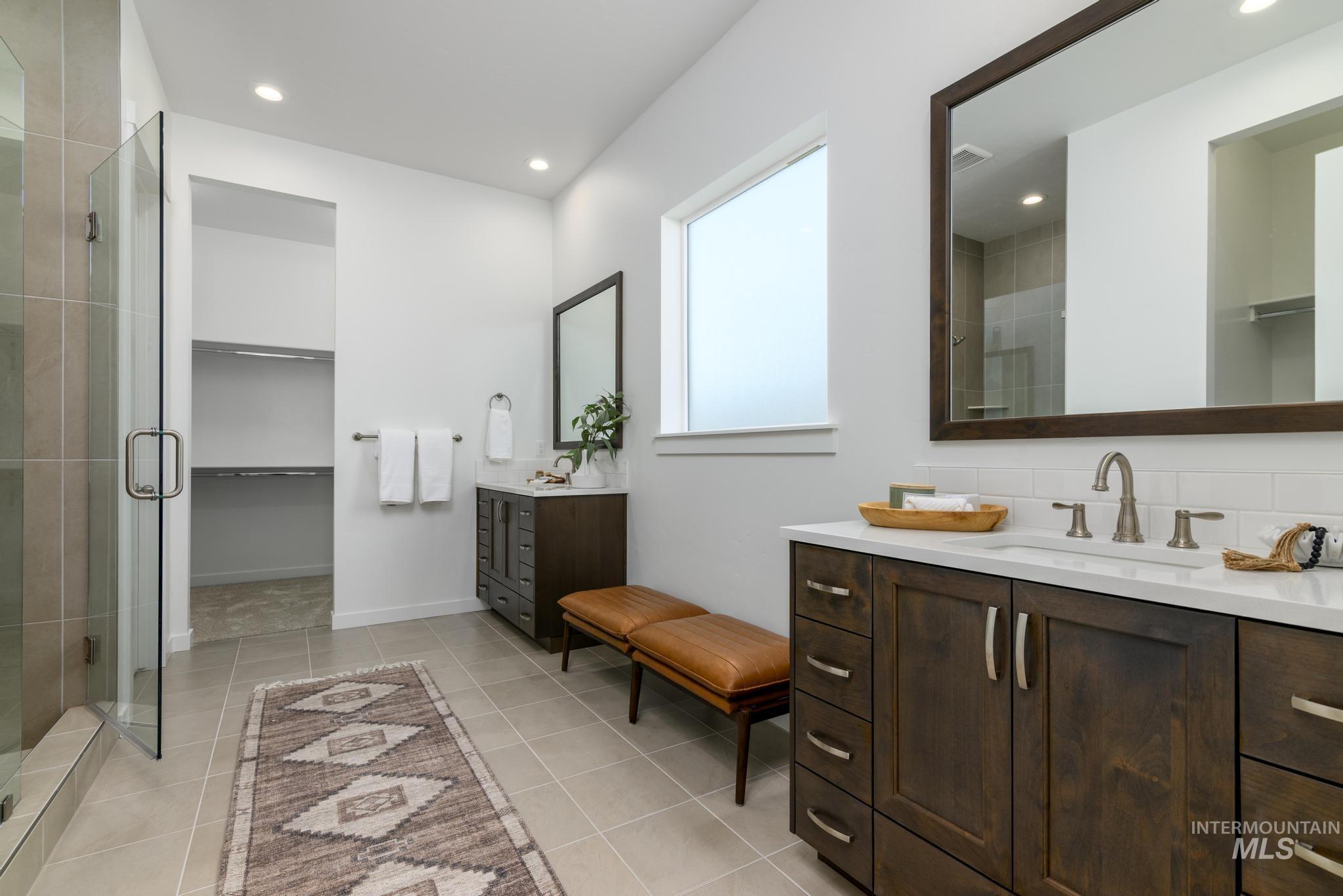 5324 Sparky Avenue Caldwell, ID 83607 - Photo 9 of 10 Bathroom with a spacious closet, two vanities, recessed lighting, a stall shower, and light tile patterned floors