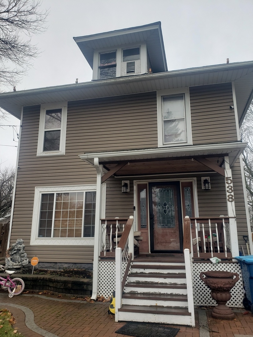 a front view of a house with stairs