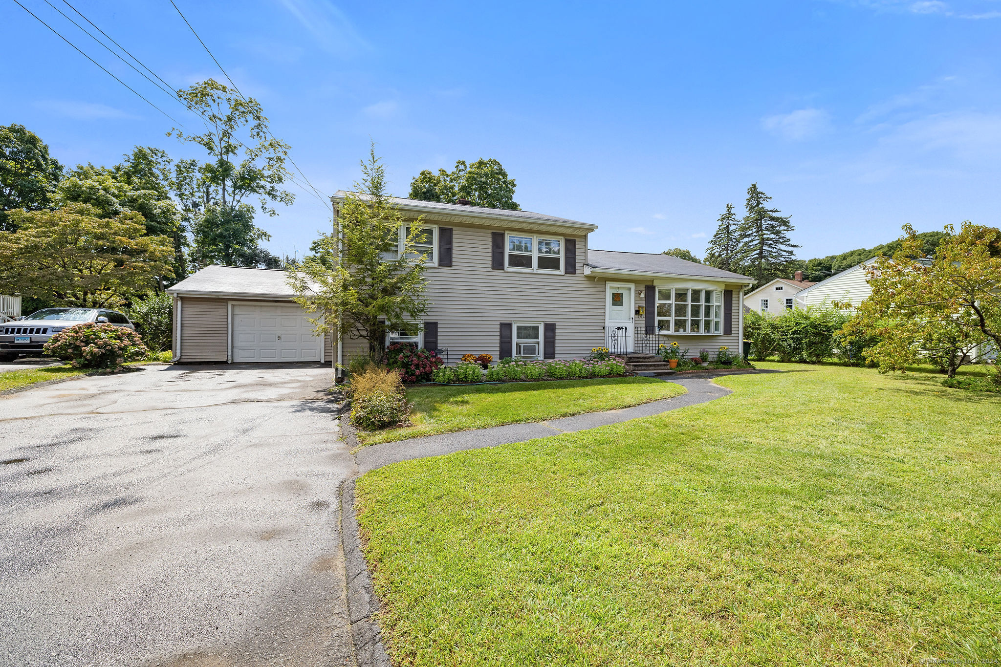 6 Triangle Terrace Danbury, CT 06810 - Photo 1 of 1 a front view of a house with garden