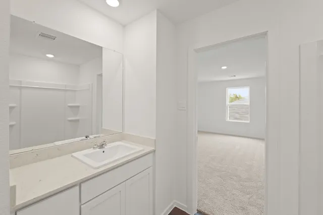 a bathroom with a sink double vanity and a mirror