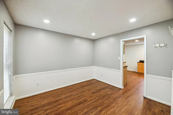 a view of hallway with wooden floor