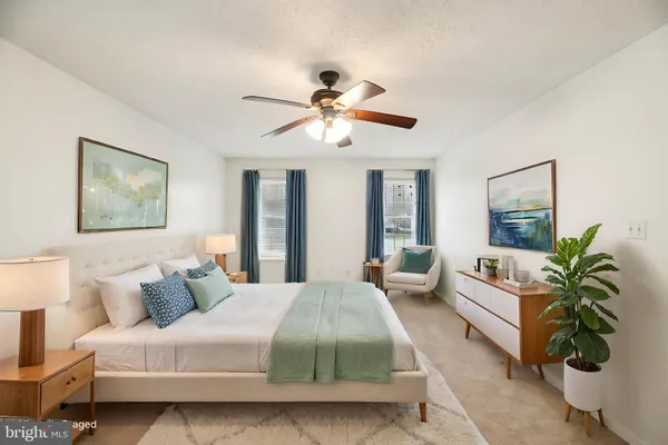 a bathroom with a toilet sink vanity granite and mirror