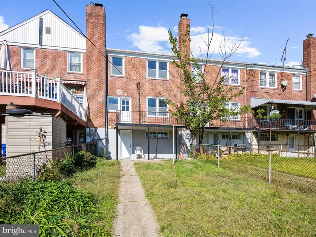 a front view of a building with a yard