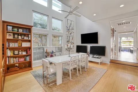 a view of a livingroom with furniture and a flat screen tv