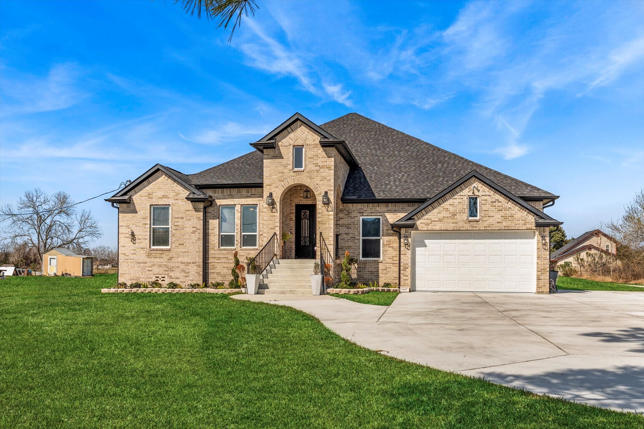 a front view of a house with a yard and garage