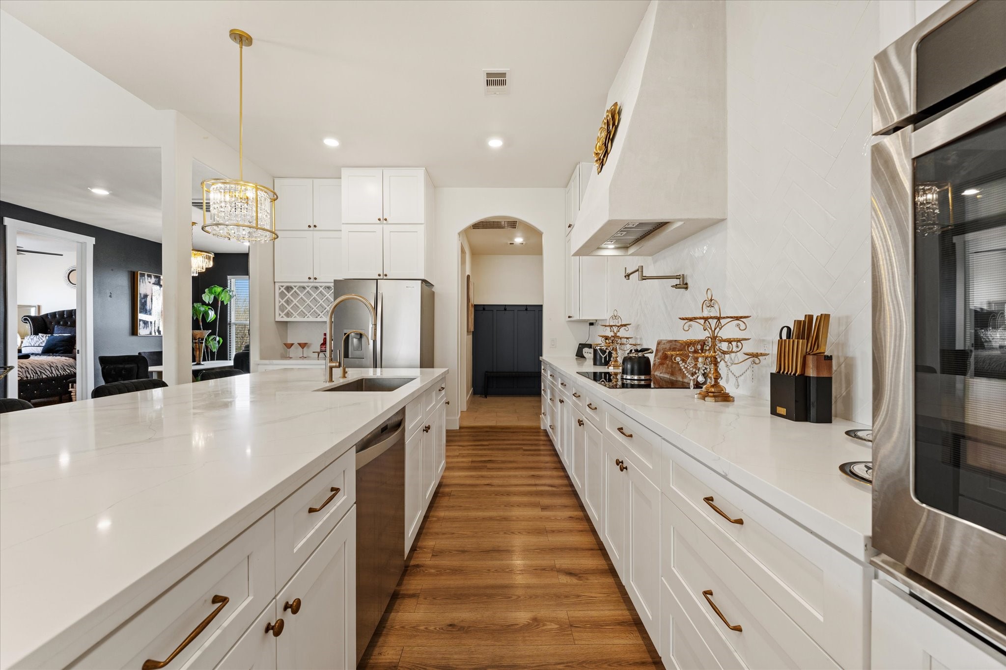 4627 County Road 63 Rosharon, TX 77583 - Photo 10 of 34 a large kitchen with stainless steel appliances kitchen island a large counter top a stove a chimney a sink and a refrigerator